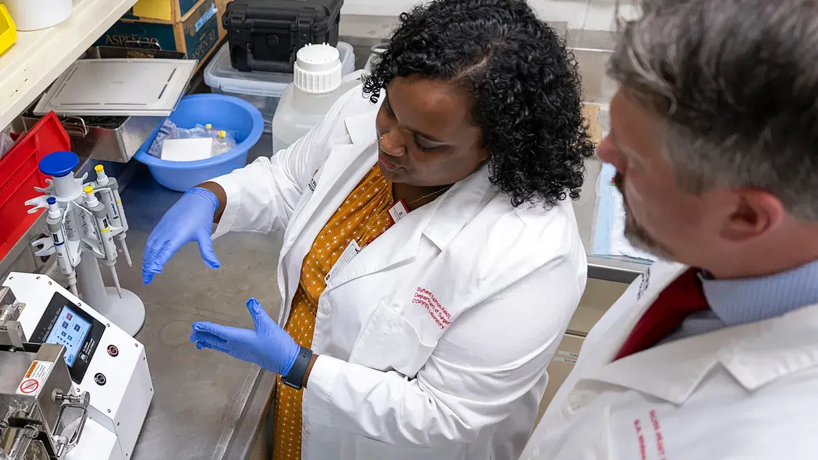 female researcher showing a male researcher medical device