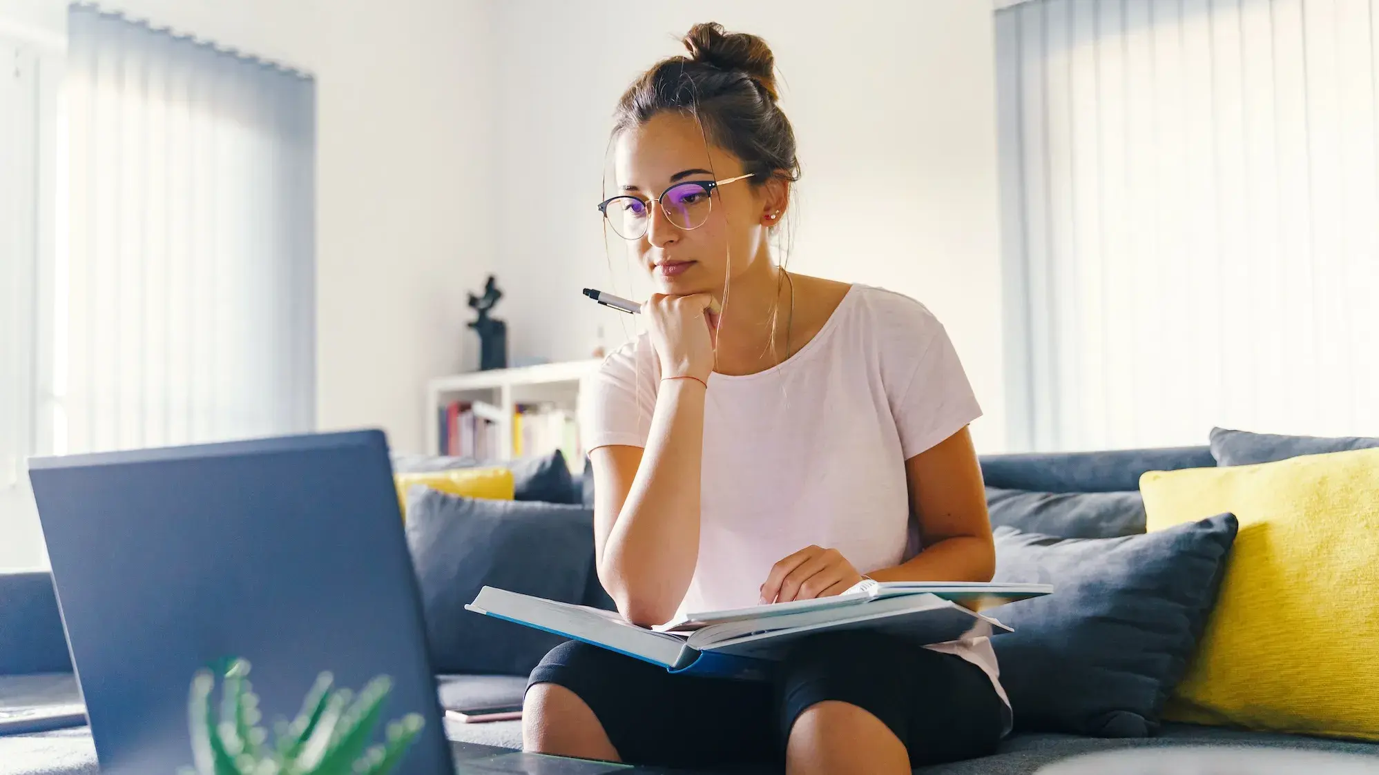 Woman sitting on couch and studying