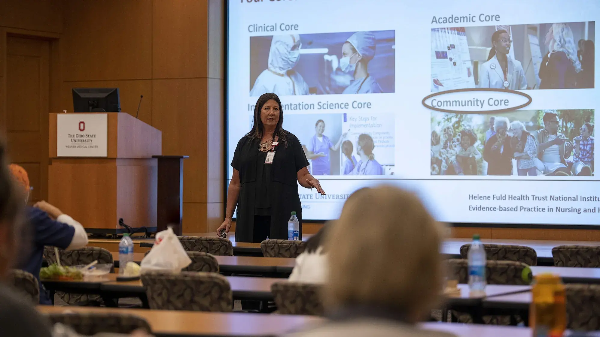 Woman presenting to lecture hall