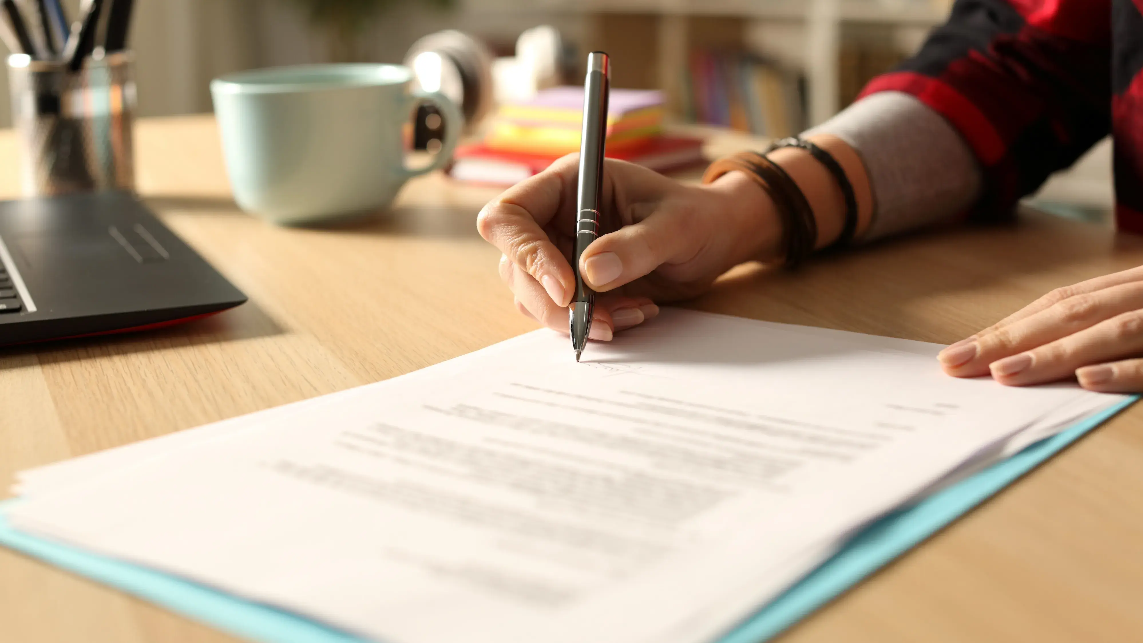 Person writing on desk