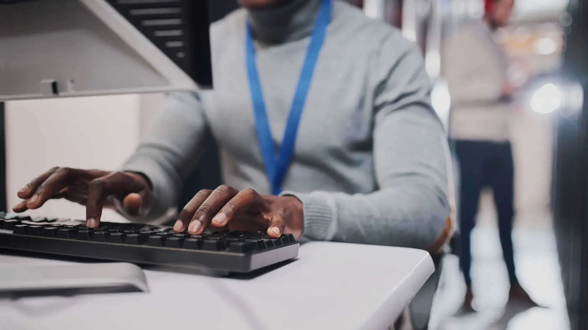 Person typing at computer