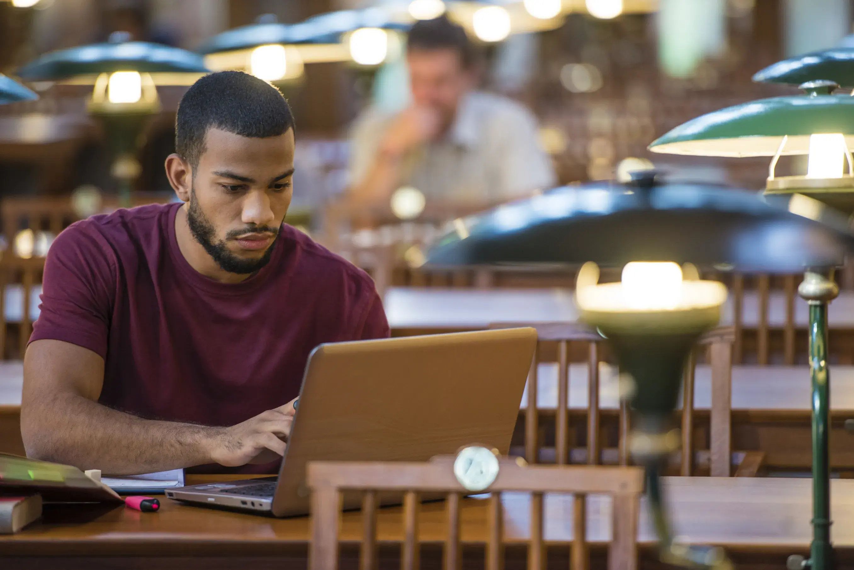 Man writing a grant on computer