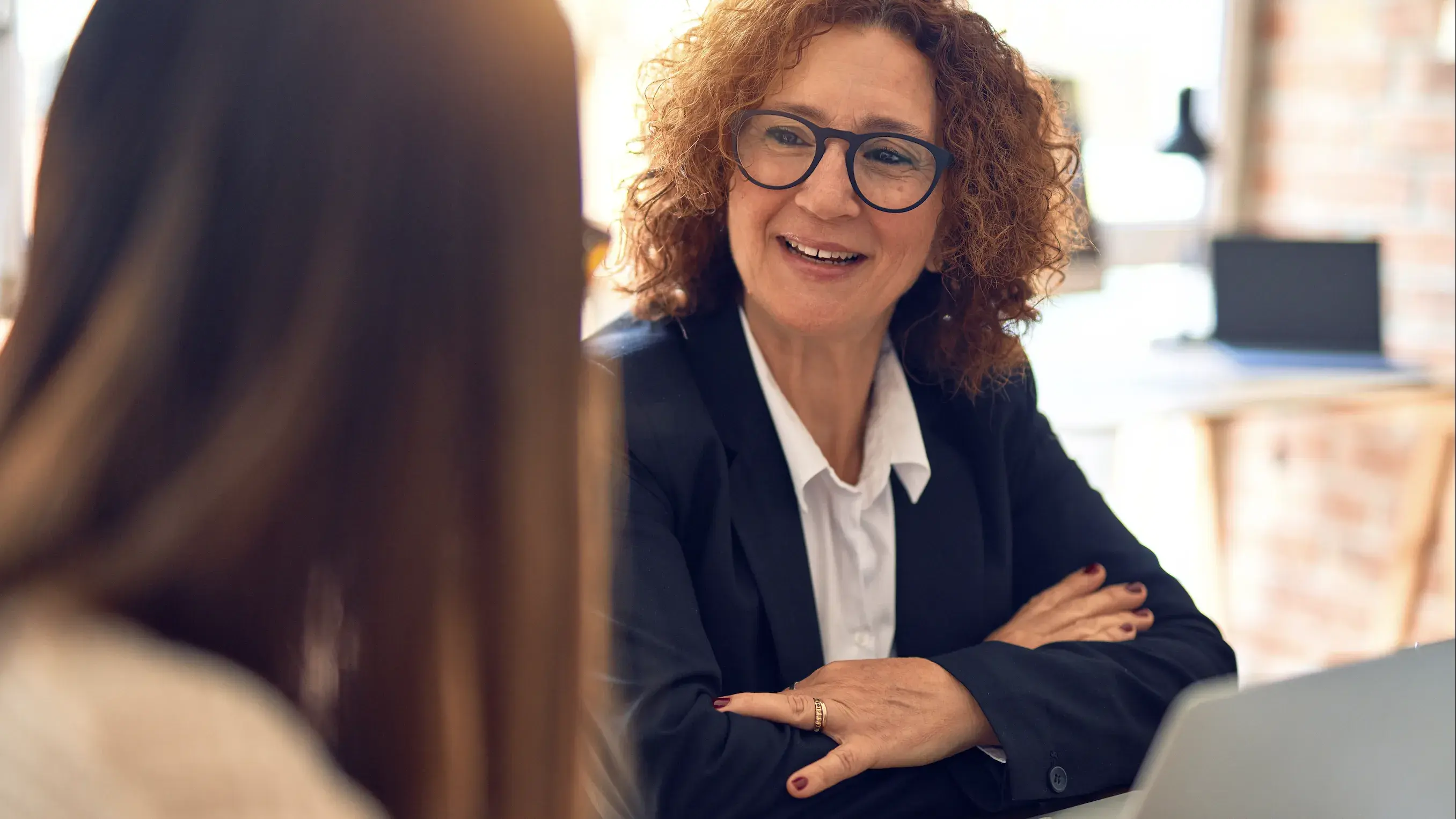 Two women discussing biostatistics at a table 