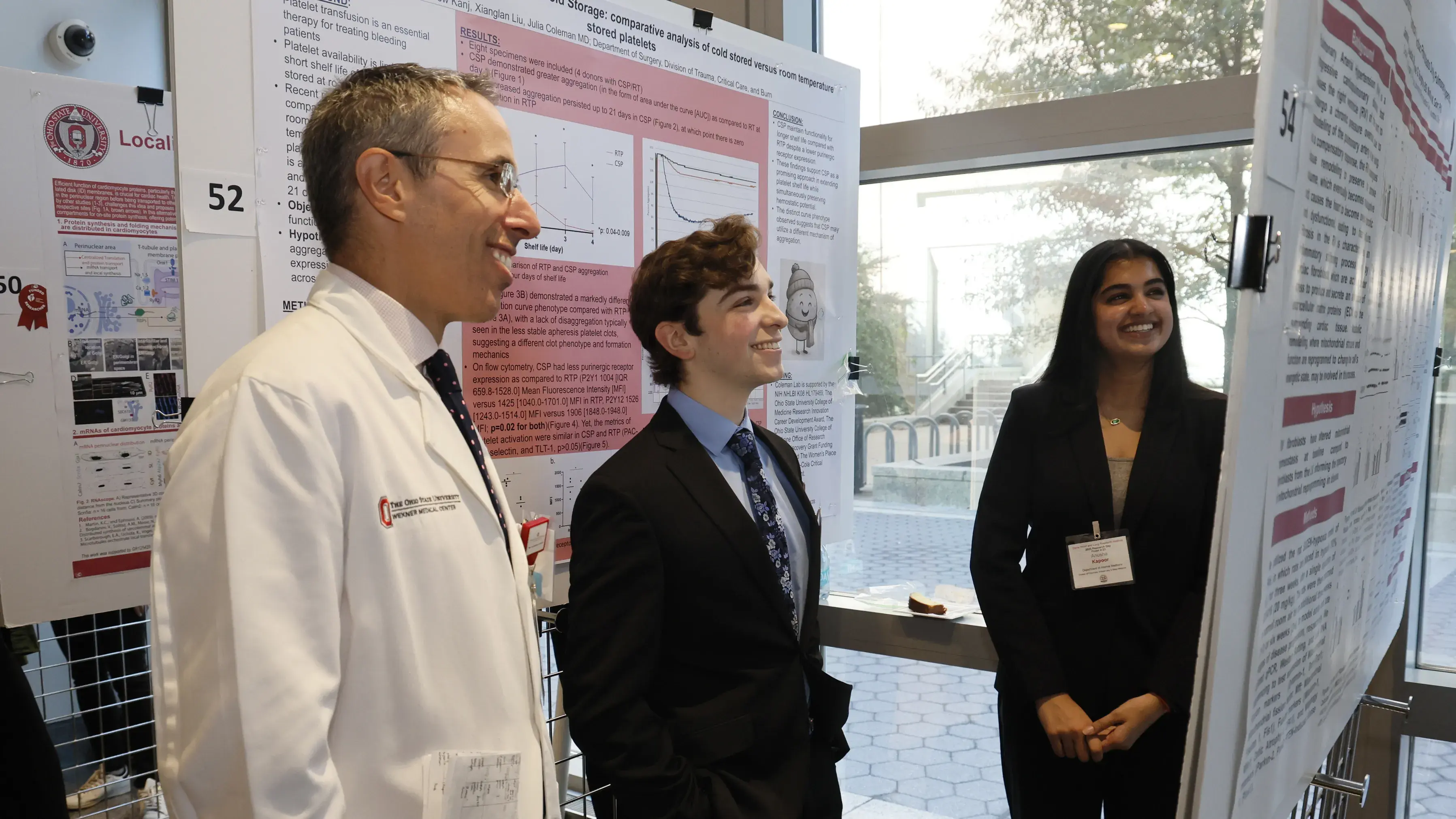 awardee and mentor reviewing a poster